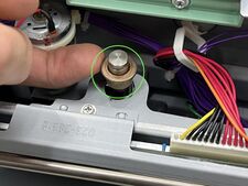 Carefully lifting the upper bushing out of the hook.