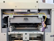 The two cables and small cable guide above them are marked in purple; the 2 screws holding the unit in are marked in green.