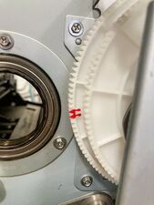 —while a pair of teeth are marked on the larger of the two second paper feed gears.