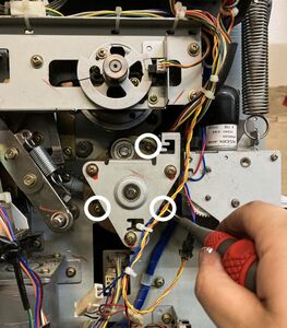 Loosening the 3 screws in the paper feed clutch base.