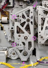 The main drive cover is held on with 5 screws, each at the base of one of its struts.